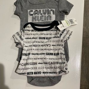 Two Calvin Klein onesies newborn